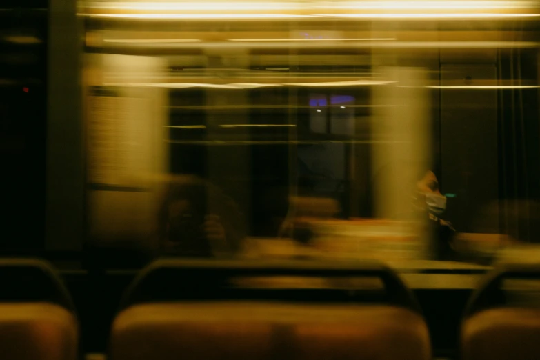 a blurry image of a couple sitting down by a table