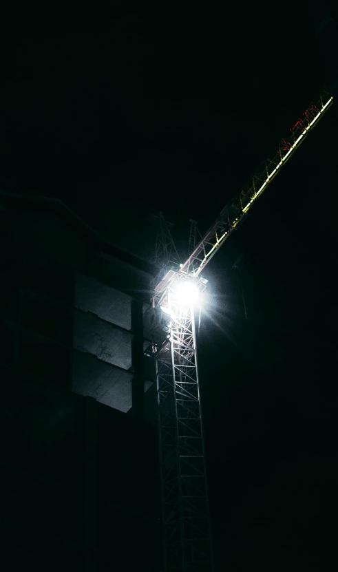 light on a metal pole at night with dark sky