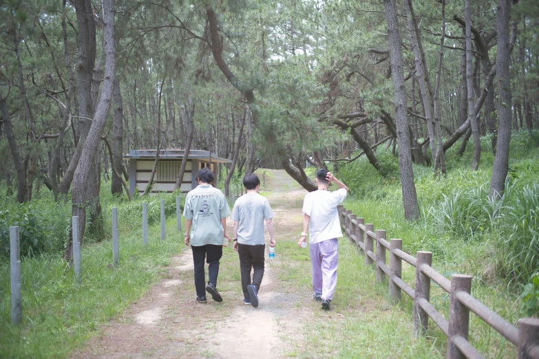 two men walking in the woods while holding onto each other's string