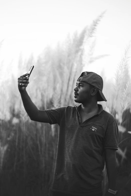 a man is taking a selfie while standing with his cellphone