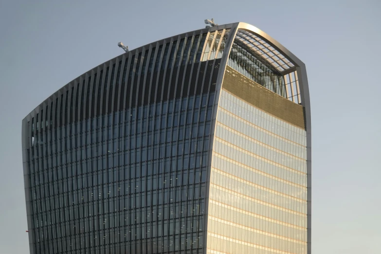 an unusual looking building in front of a bright sky