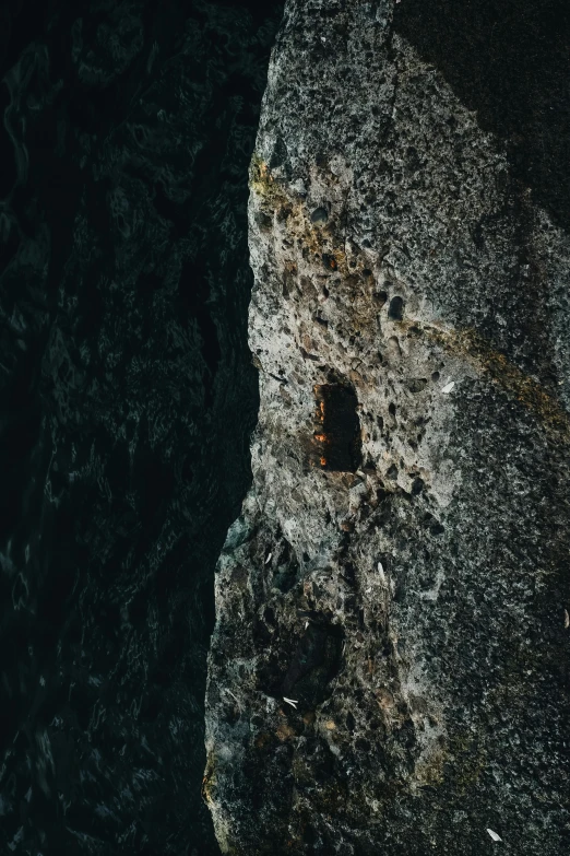 a view from above looking down onto a rock outcropping in the middle of the ocean