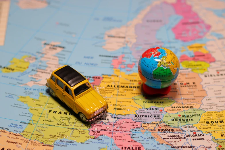 a small toy car is on the map of europe