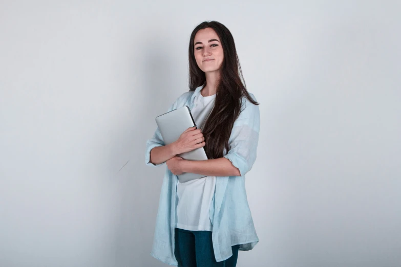 a woman in jeans and white shirt posing for the camera