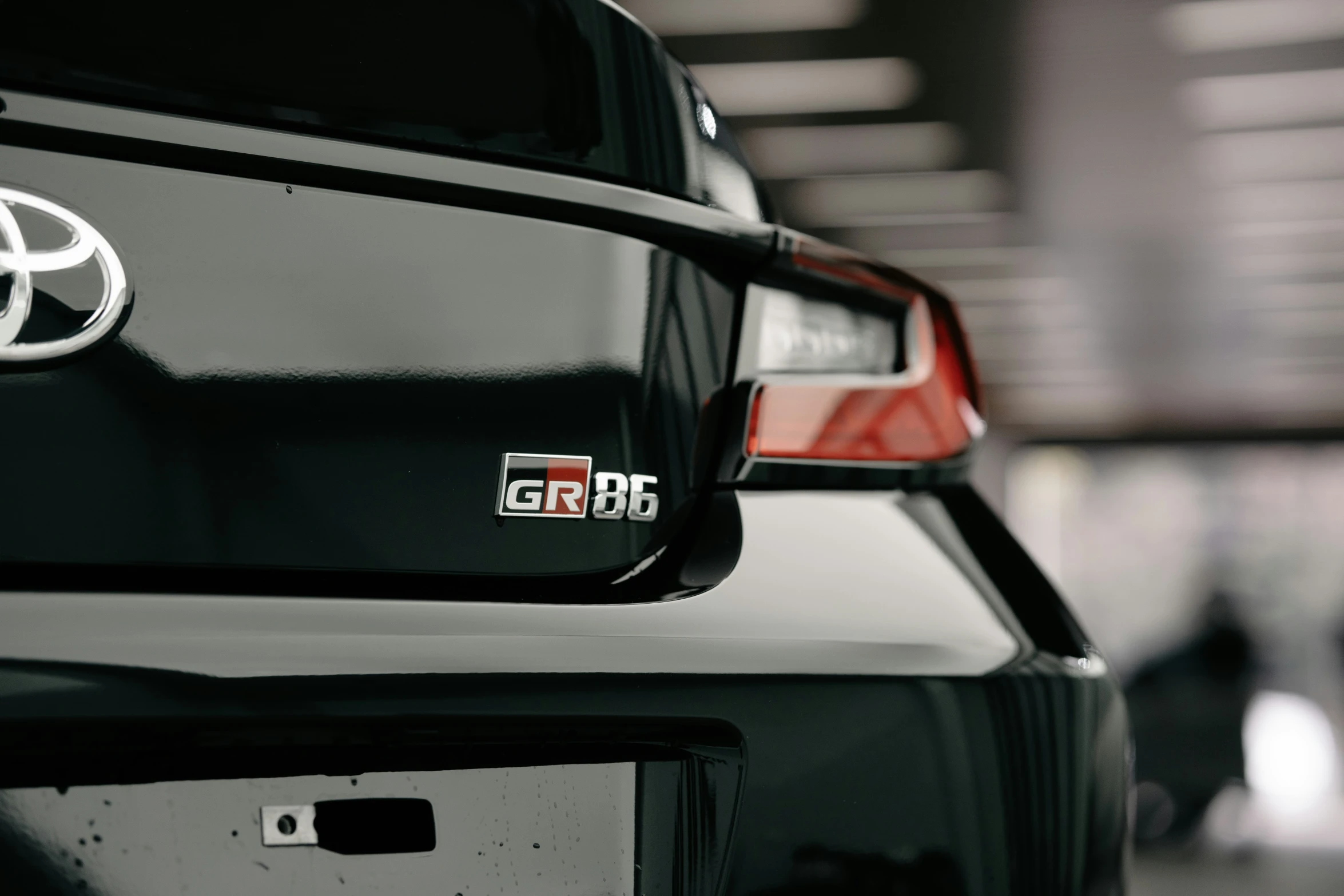 the back of a black car that has the emblem and badge on it