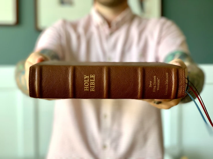 the book is held in a man's hand