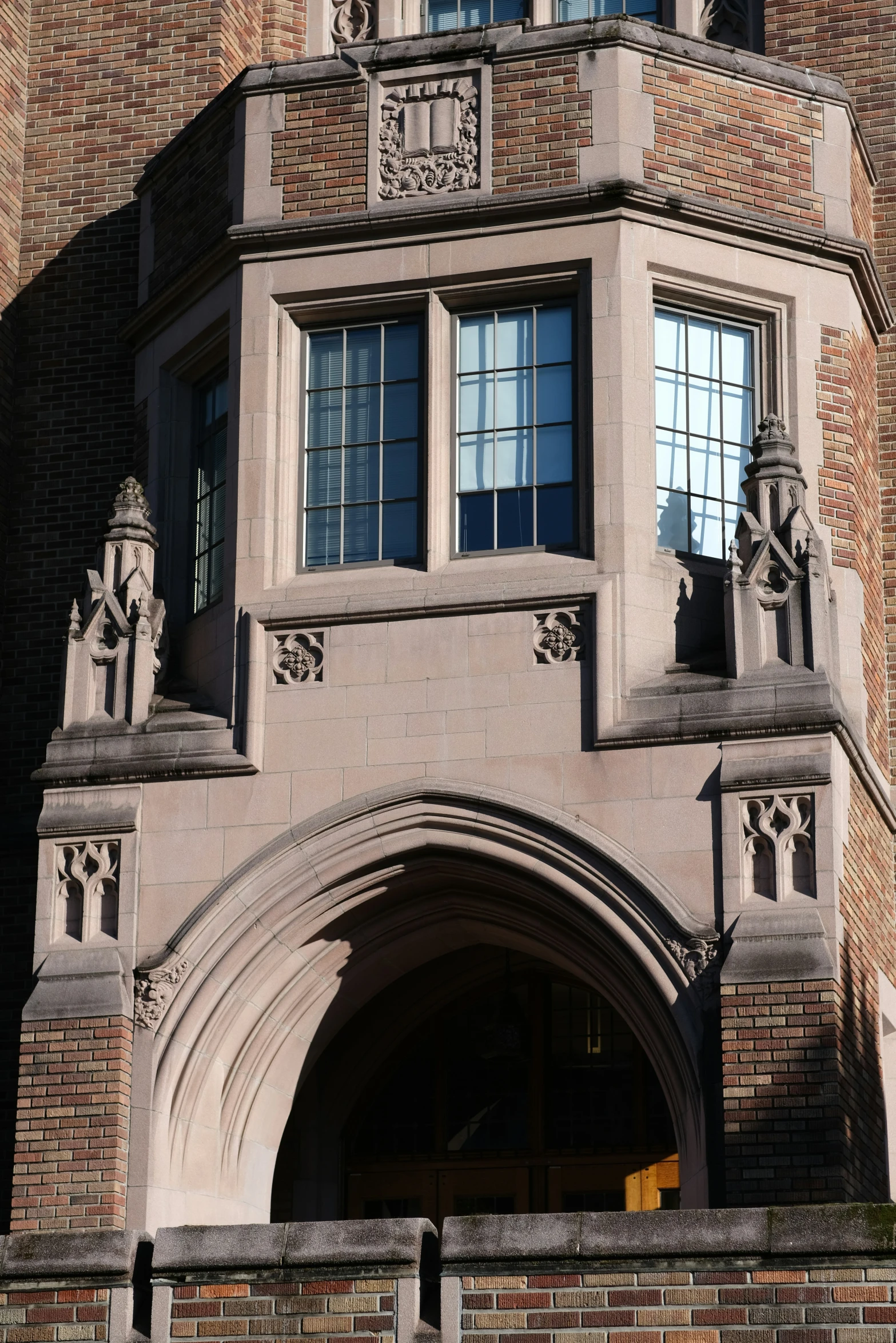 a tall brick building with arched doorways and windows