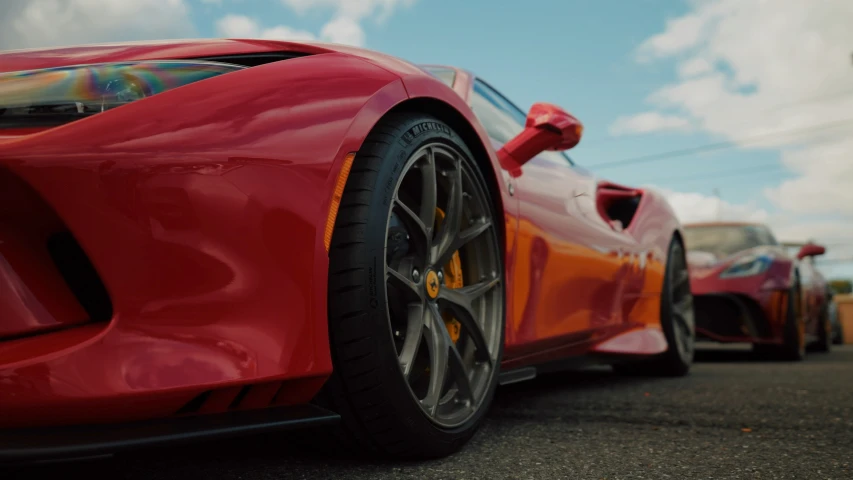 an orange sports car parked next to another one