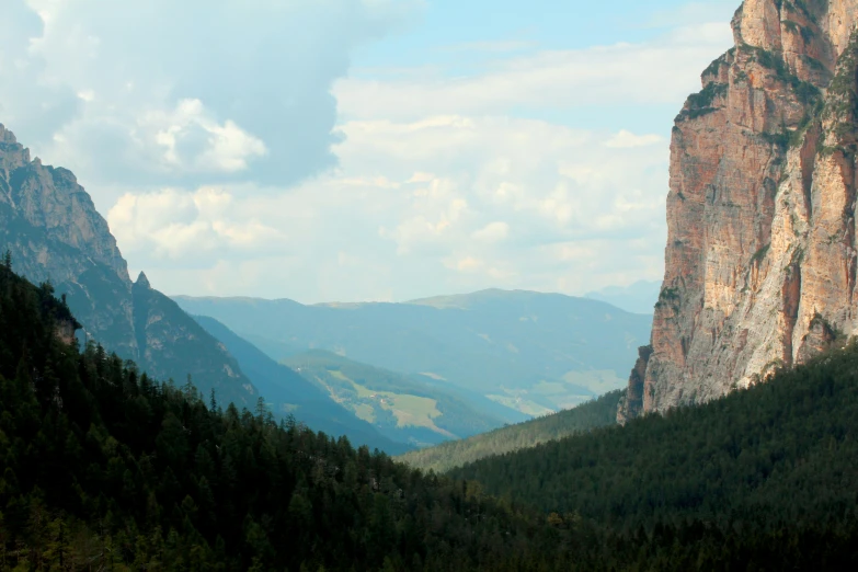 there is a small mountain range with very tall mountains in the distance