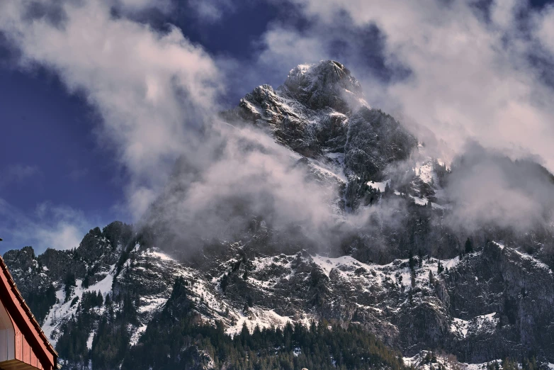 the view from the top of the mountain in snow and clouds