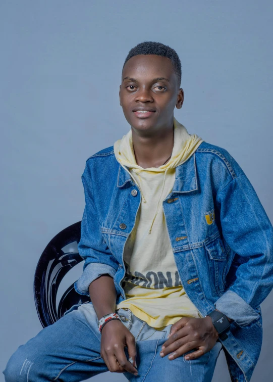 a man sitting down and wearing blue jeans