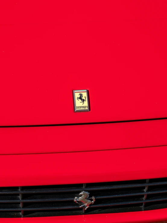 a bright red car is shown with a logo on it