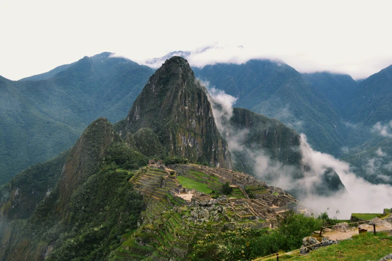 the mountains are covered in mist and low clouds