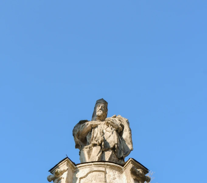 a statue of an angel atop a building with a clear sky