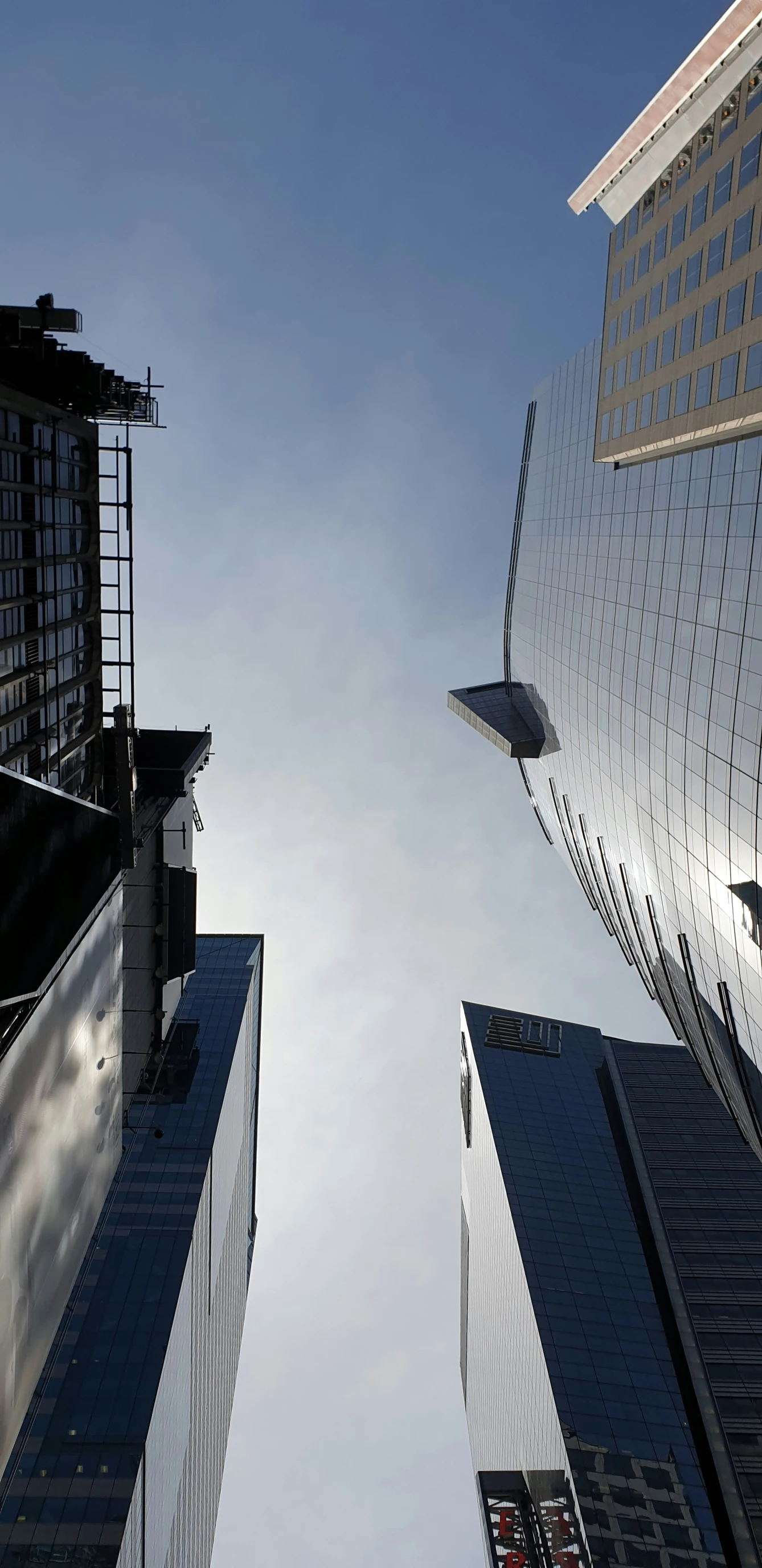 the skyline view shows two very tall buildings in the foreground