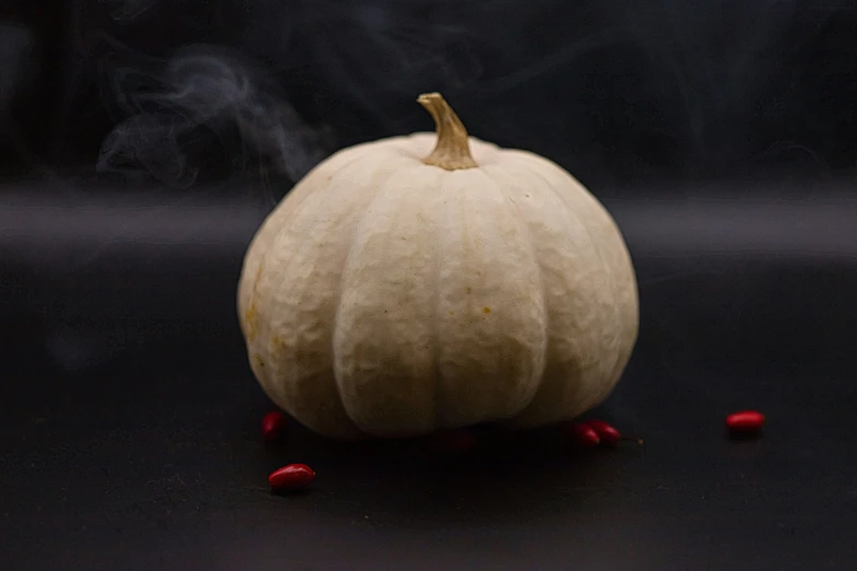 a white pumpkin sitting on top of a table