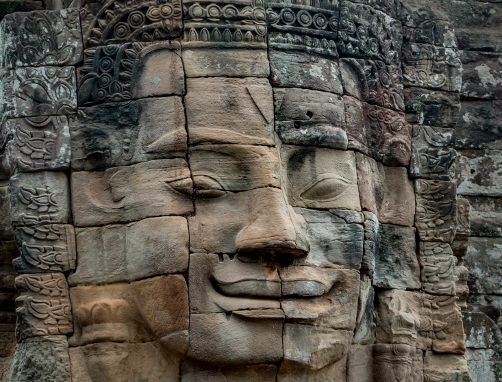 an image of an ancient sculpture with faces carved into it