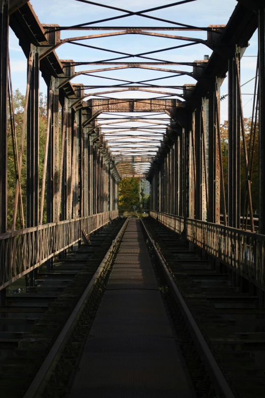 an empty bridge that is partially closed with lots of wires in the ceiling