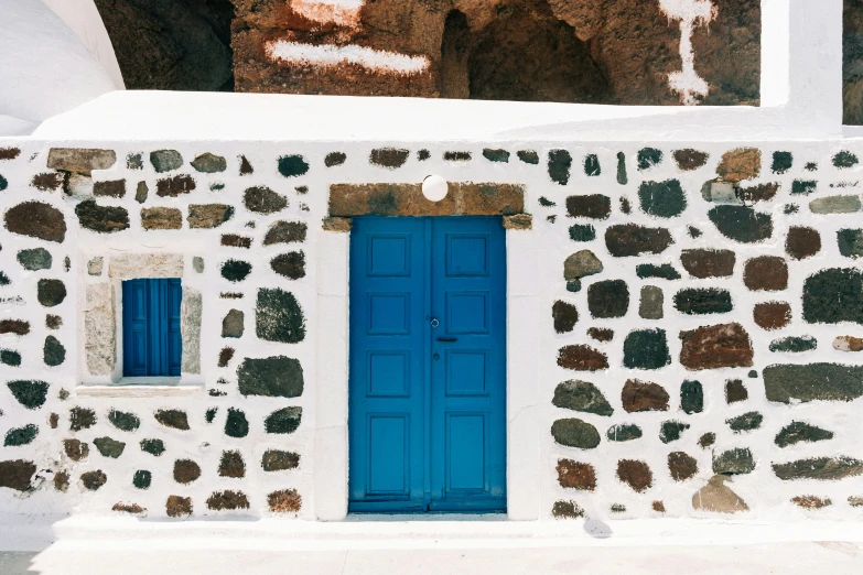 a very colorful door is next to an old building