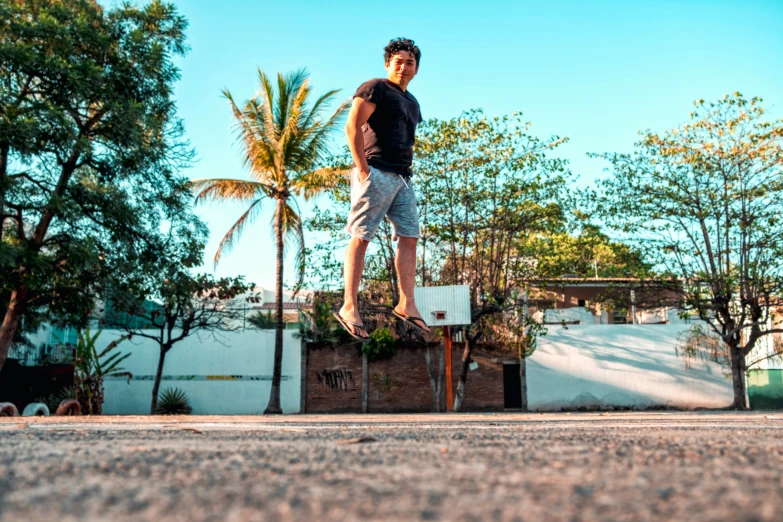 young man on a skateboard with trees in the background