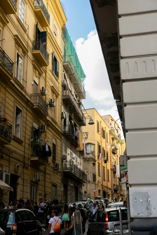 many buildings are shown on the street near some parked cars