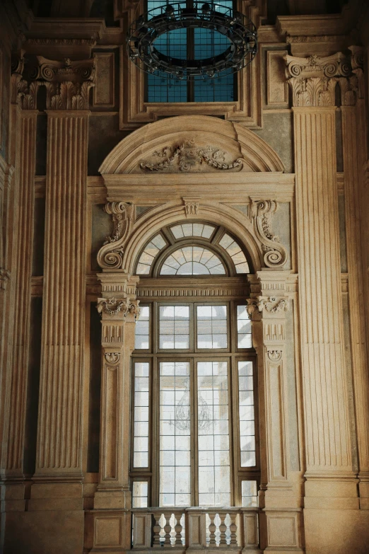 a window in an old building next to some decorative pillars