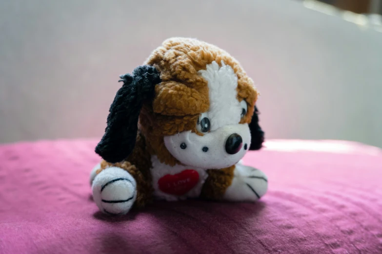 a stuffed dog with a black ribbon around it's head