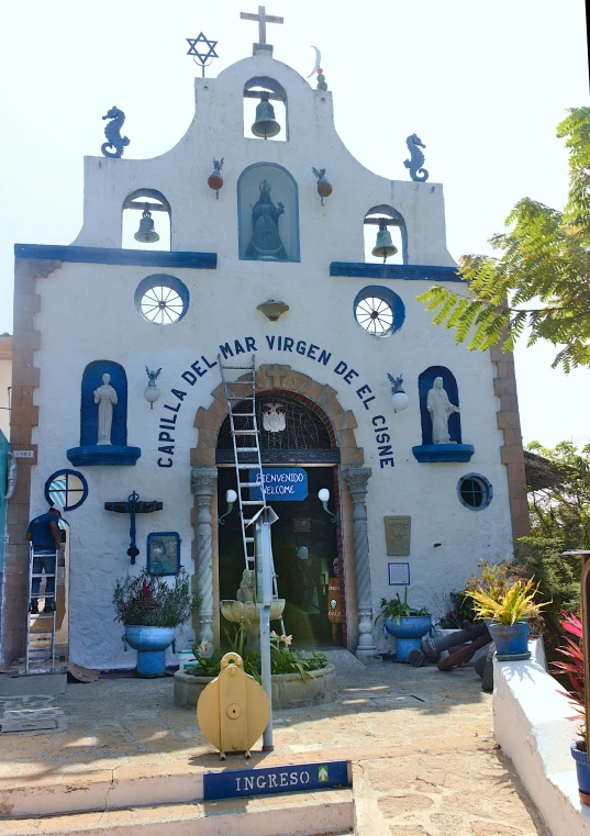 a church with several bells and crosses on the wall