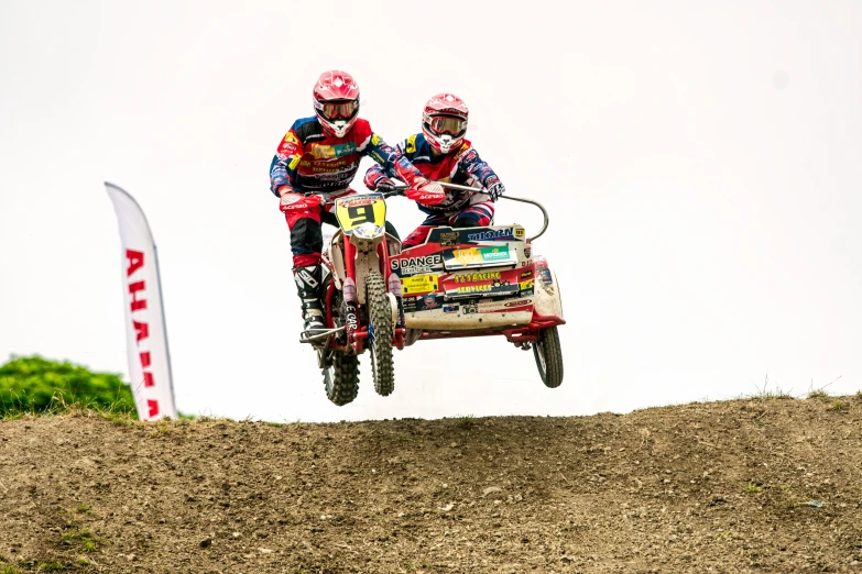 two men riding on top of two vehicles