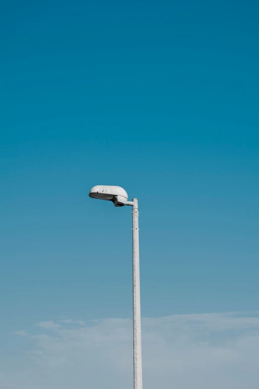 an airplane flying through the sky over a pole with a snow covered head