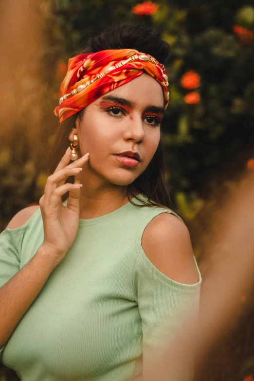 the girl is posing for the camera with her hair in a knot