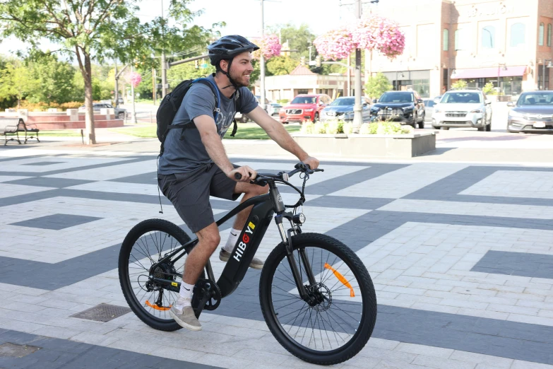 a man that is sitting on a bicycle