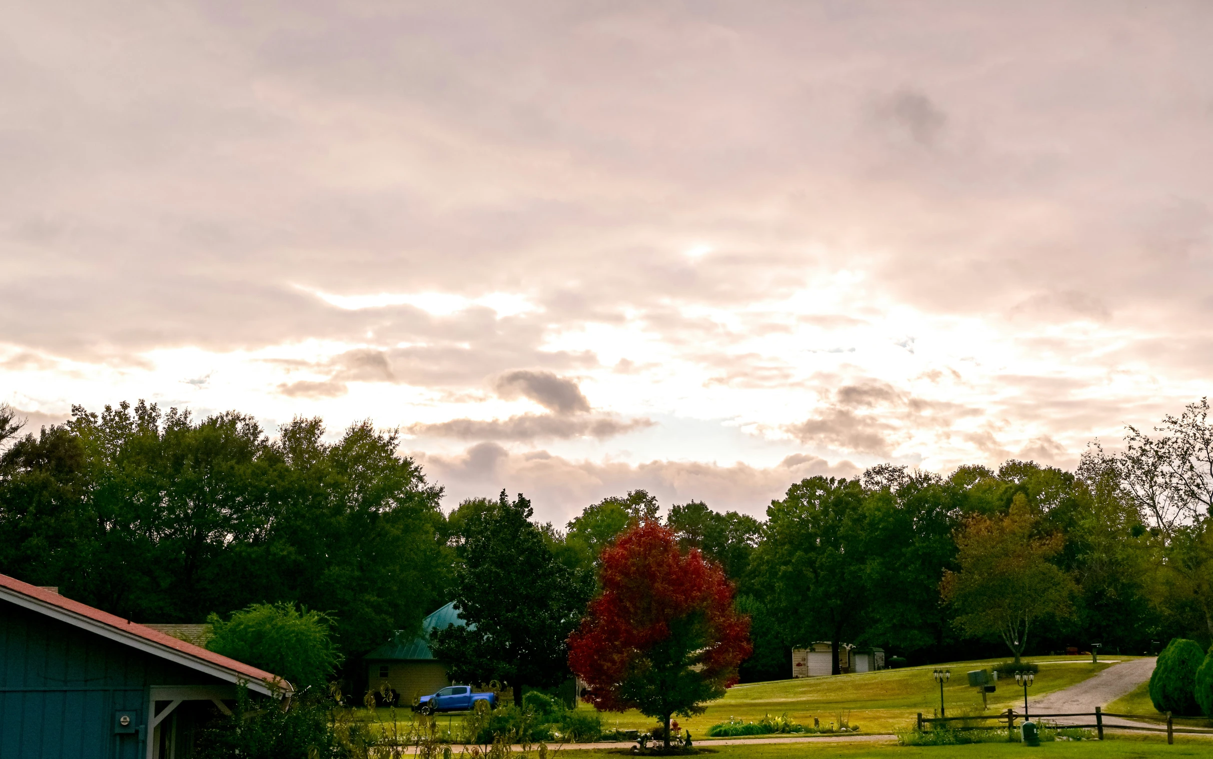 a beautiful house sits on the other side of the field