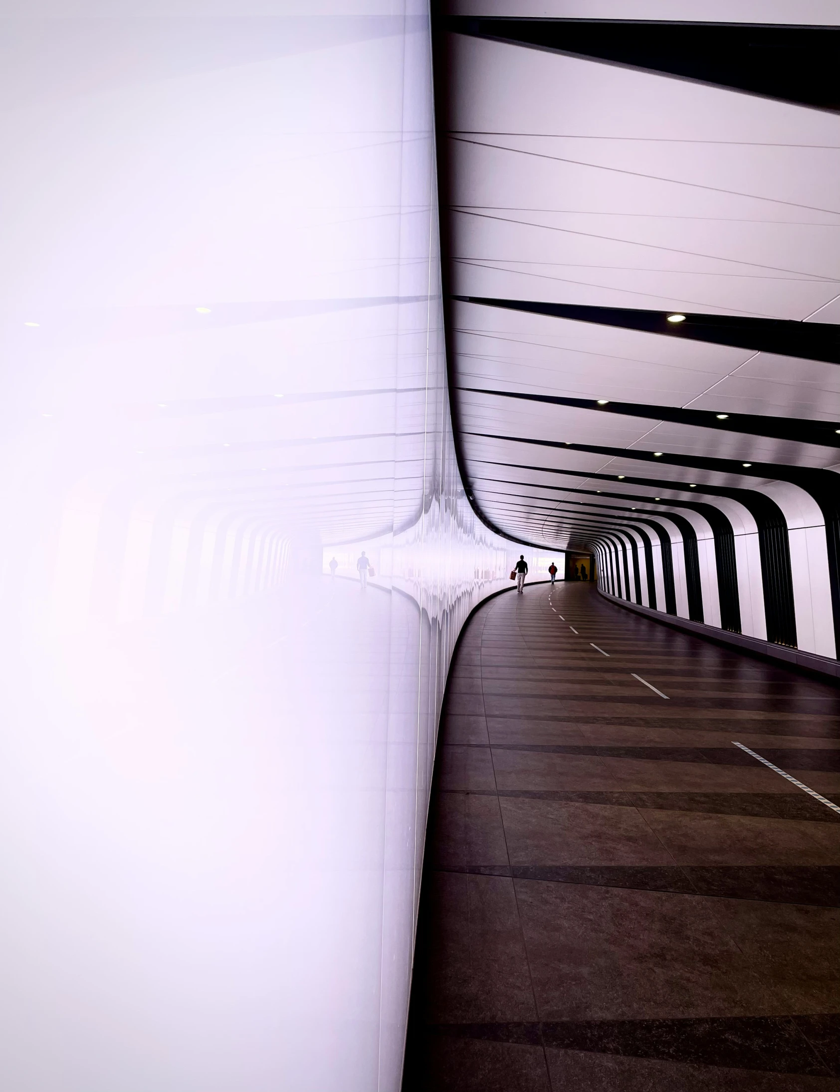 a long white line leading to an indoor tunnel