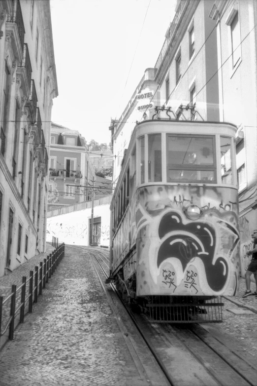 an old trolly car on tracks in a narrow alley