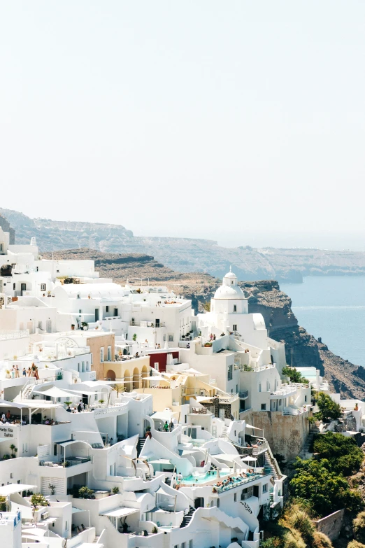 white buildings along the cliff side on the side of a body of water