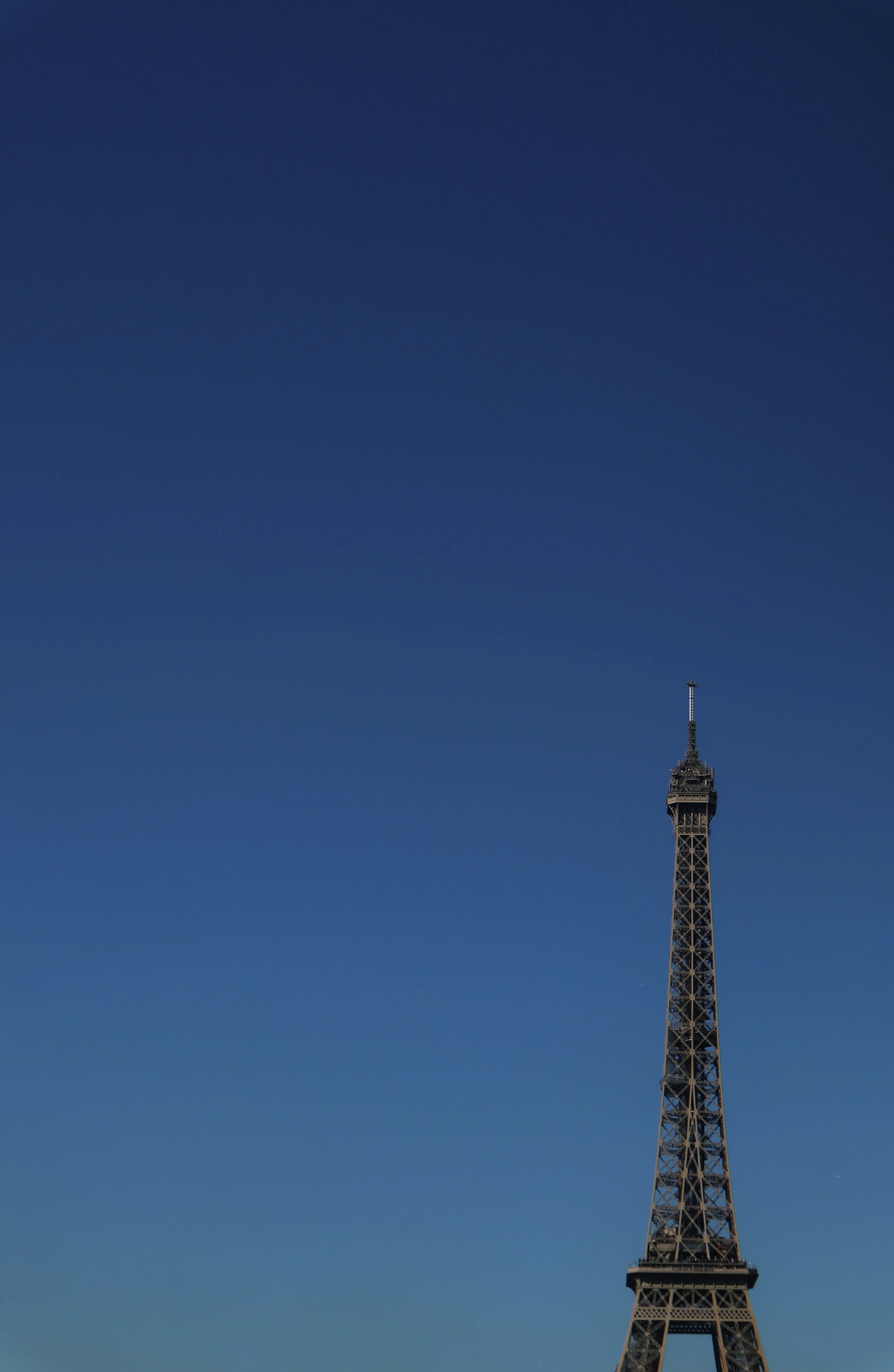 the eiffel tower stands on an empty field