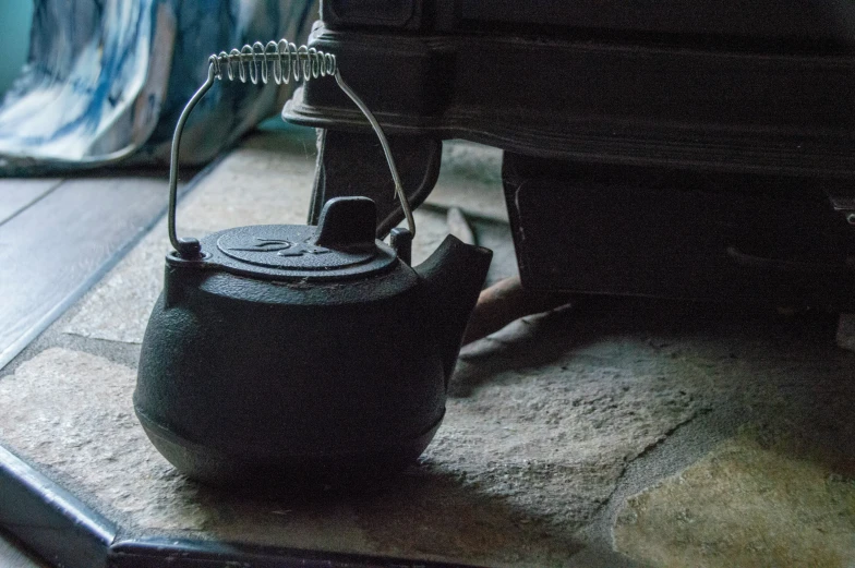 a small black object sitting on top of a floor next to some stairs