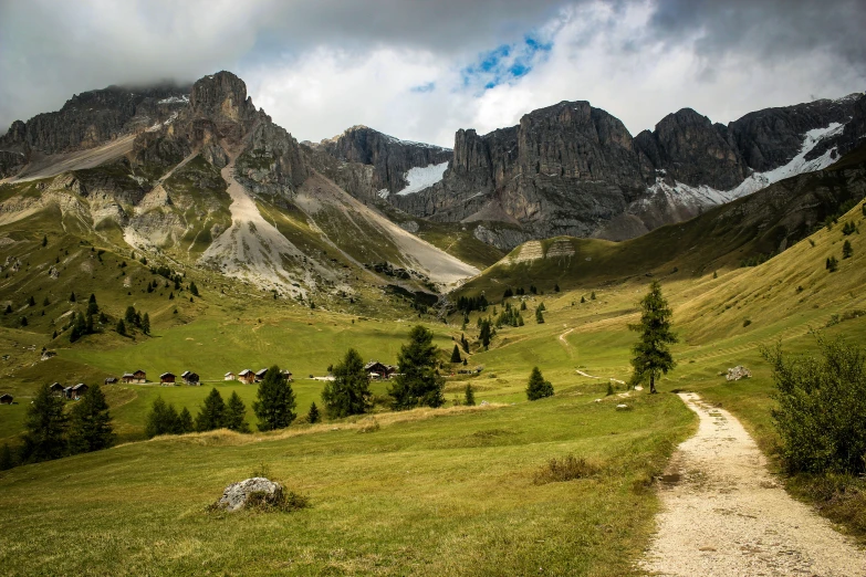 a scenic po of a mountain side with a trail running through it