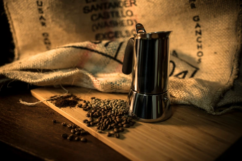 the ground coffee is sitting next to a coffee grinder