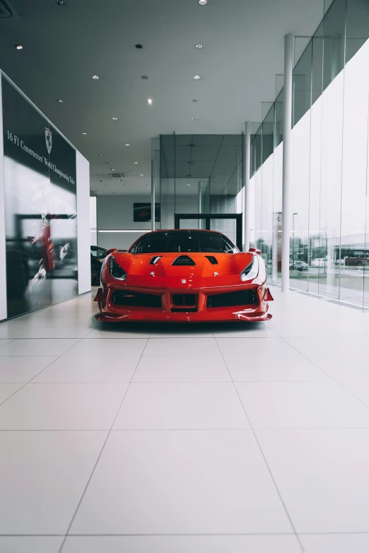 the ferrari sports car is parked inside a building