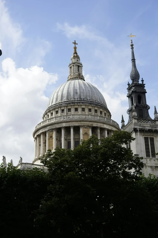 a domed building with a tower and cross on top