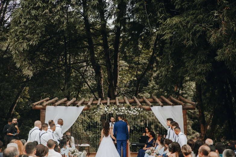 the bride and groom are getting married at their outdoor ceremony