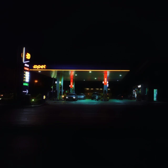 an oil station at night with neon lights