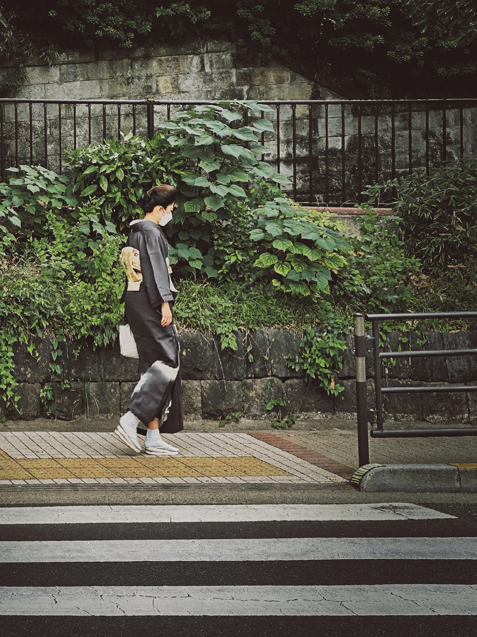 a woman with a skateboard on the side of a road