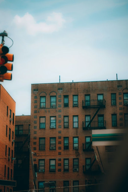 looking up at a tall brown building with several stories