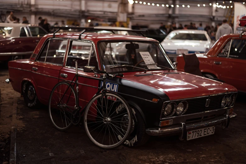 several different types of cars with bicycles hanging from them