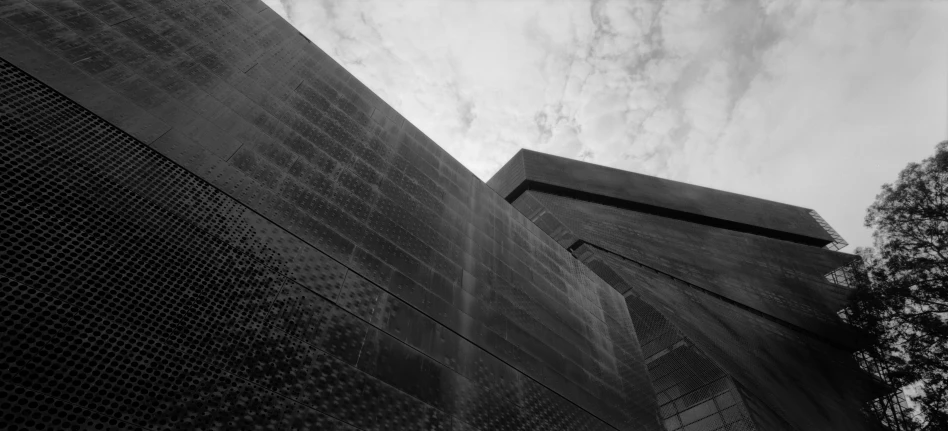 two buildings with towers under a cloudy sky