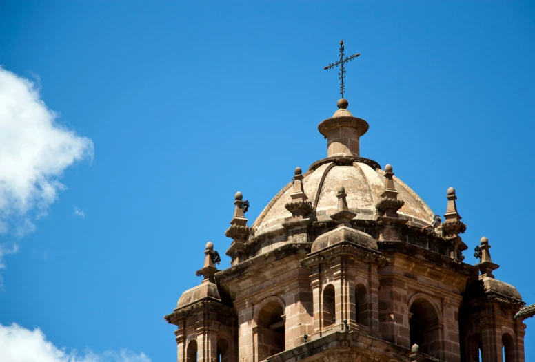 the top of an old church building with a cross on it