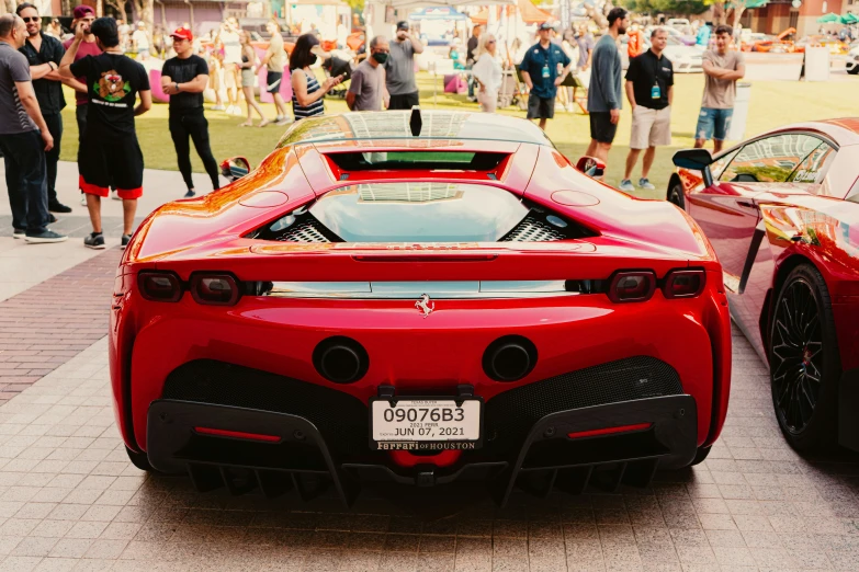 two cars in line at an event on a street